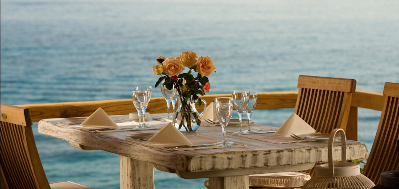 Table set for dinner in front of teh sea